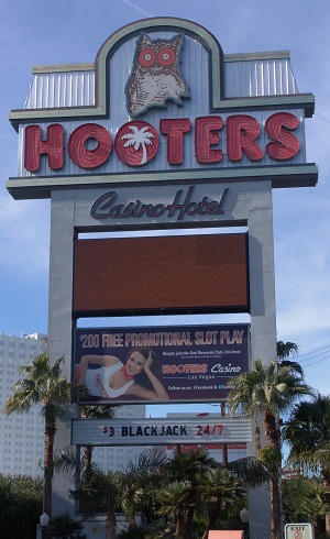 sign in front of hooters showing blackjack for 3 dollars