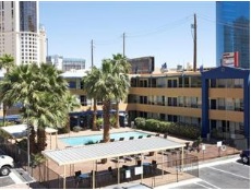 travel lodge swimming pool and courtyard scene of many parties