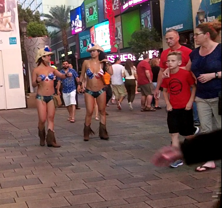 As This Family walk by these hot Buskers the son knows not to look but the Father is waiting for His Chance to Look. Not yet dad, wait for it.......