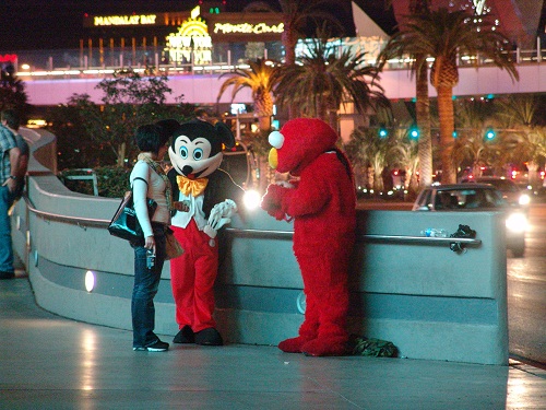 mickey and elmo in front of planet hollywood