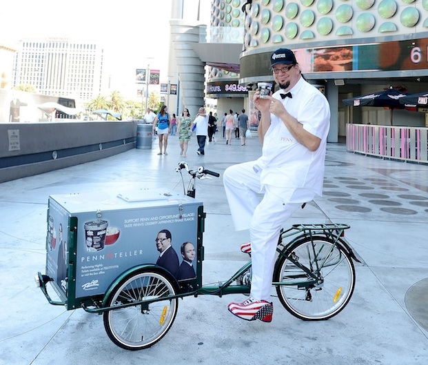 penn jillette sits on a pedal cart with walgreens ice cream