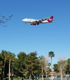 This picture shows an Aircraft approaching the landing strip with wheels down